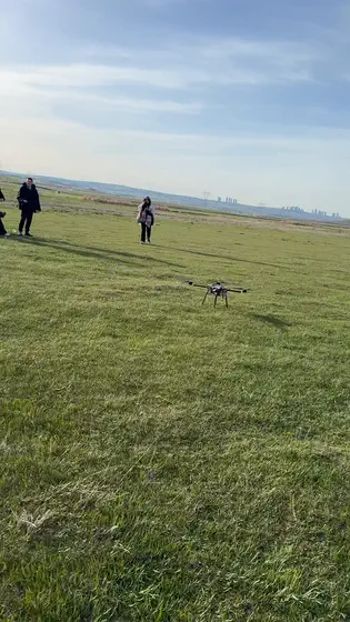 On the grass, with the team looking on